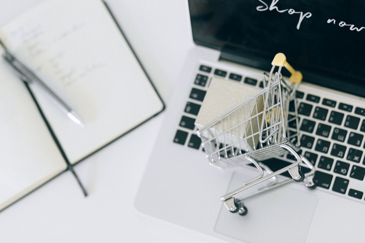Miniature shopping cart on a laptop keyboard