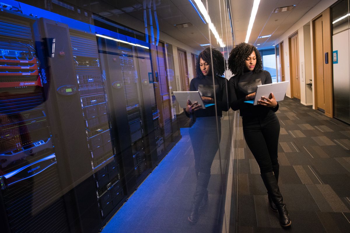 Engineer with a laptop in a server room